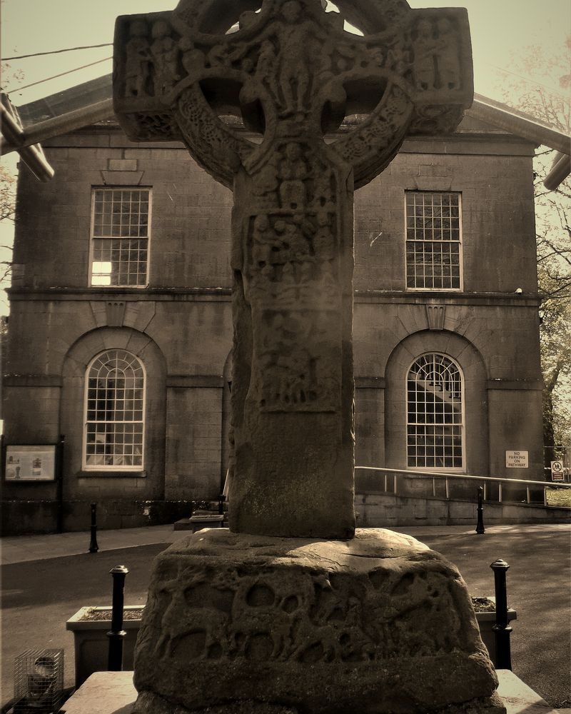 The Market Cross on Headfort Place, Kells, with a stone building behind it